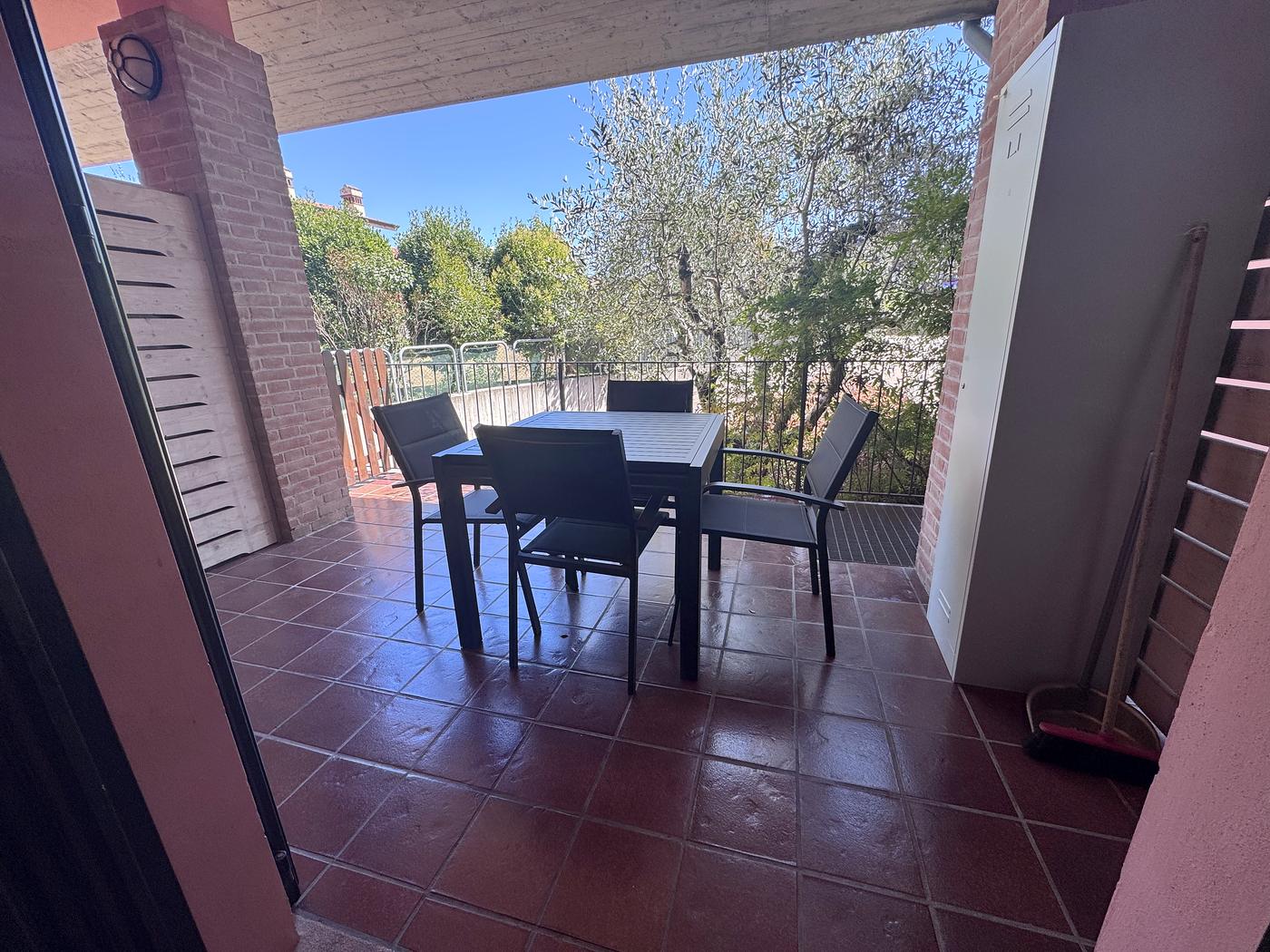 Il terrazzo arredato con tavolo e sedie, vista sugli ulivi